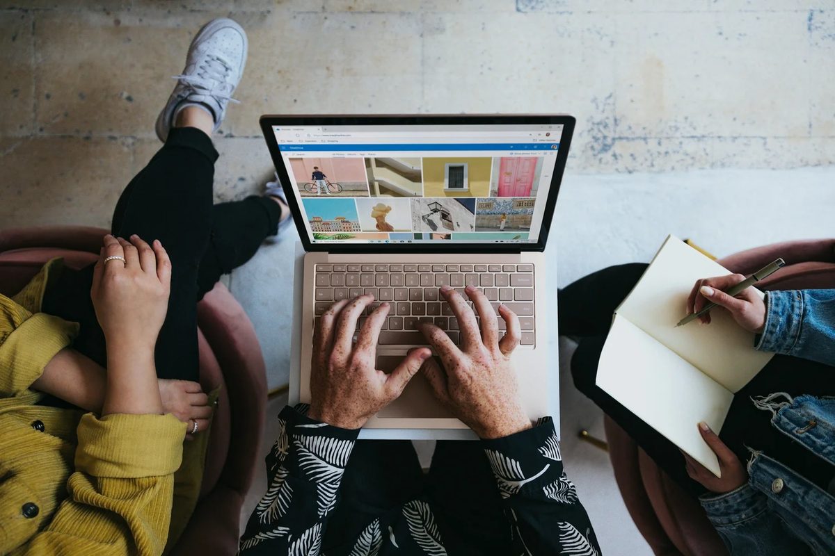 three colleagues working together on a laptop